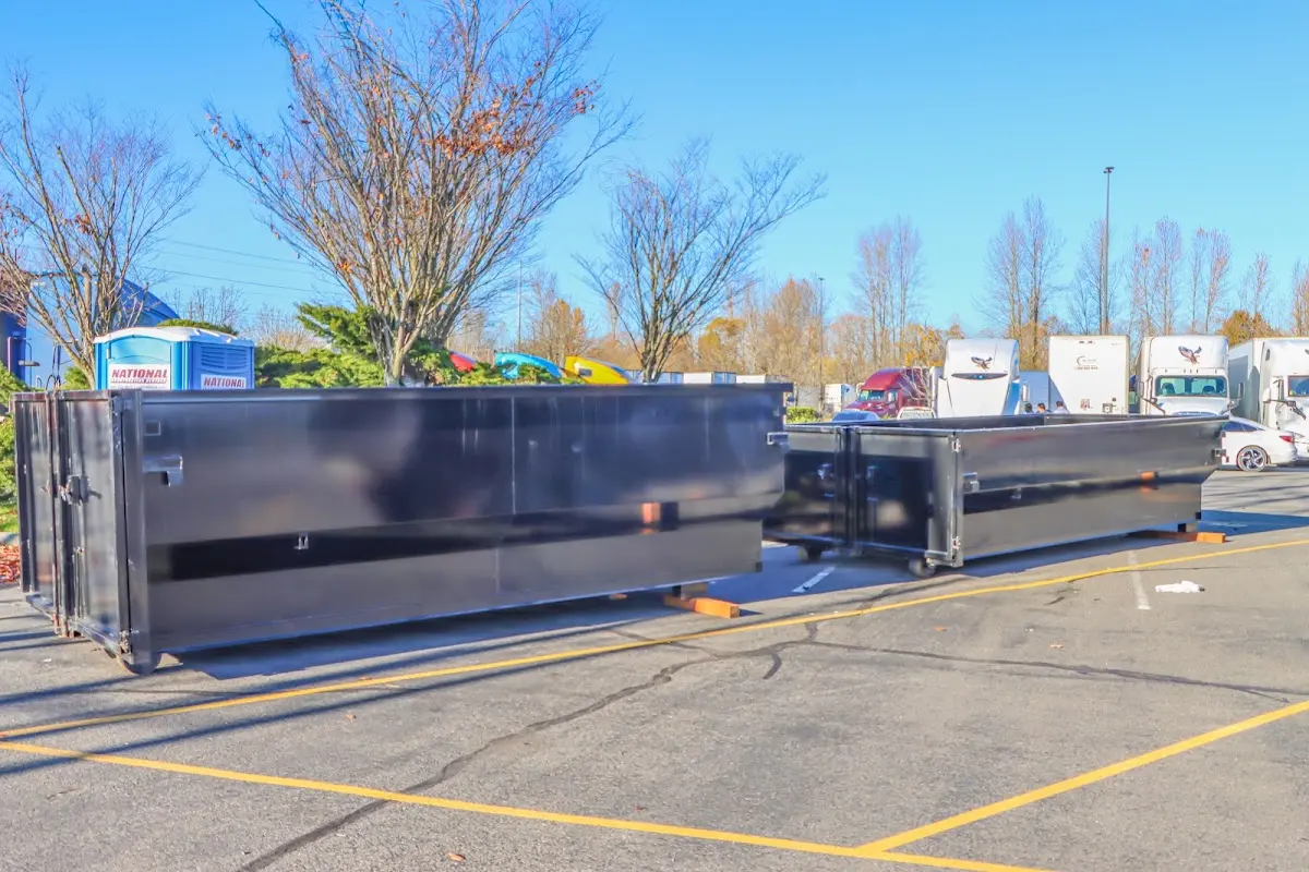 Professional dumpster rental service with roll-off container on residential driveway in Ambler